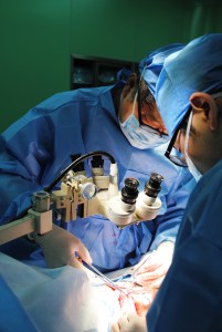 surgeons using the microscope to complete vascular anastamoses